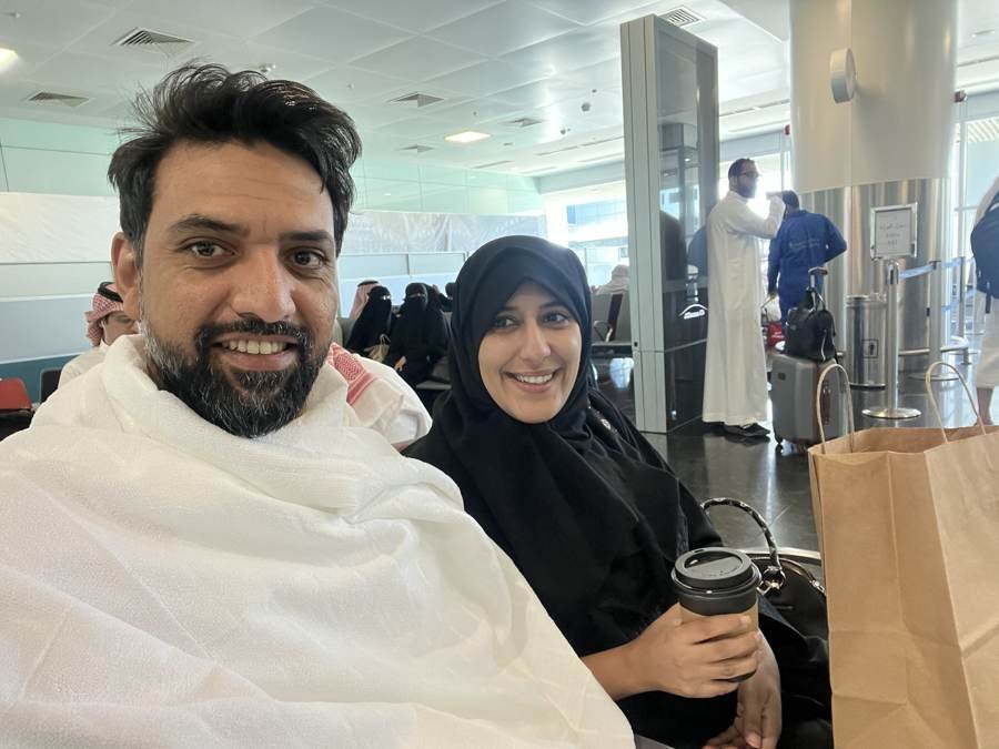 airport, ihram on, coffee in hand